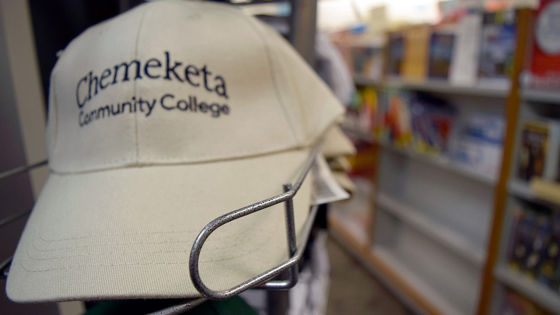 Chemeketa bookstore display of embroidered ball cap.